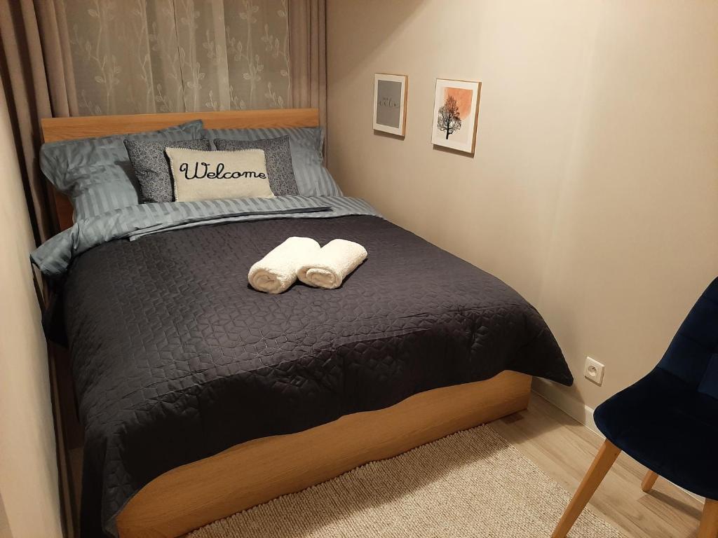 a bedroom with a bed with two towels on it at Apartament Wenecja in Grudziądz