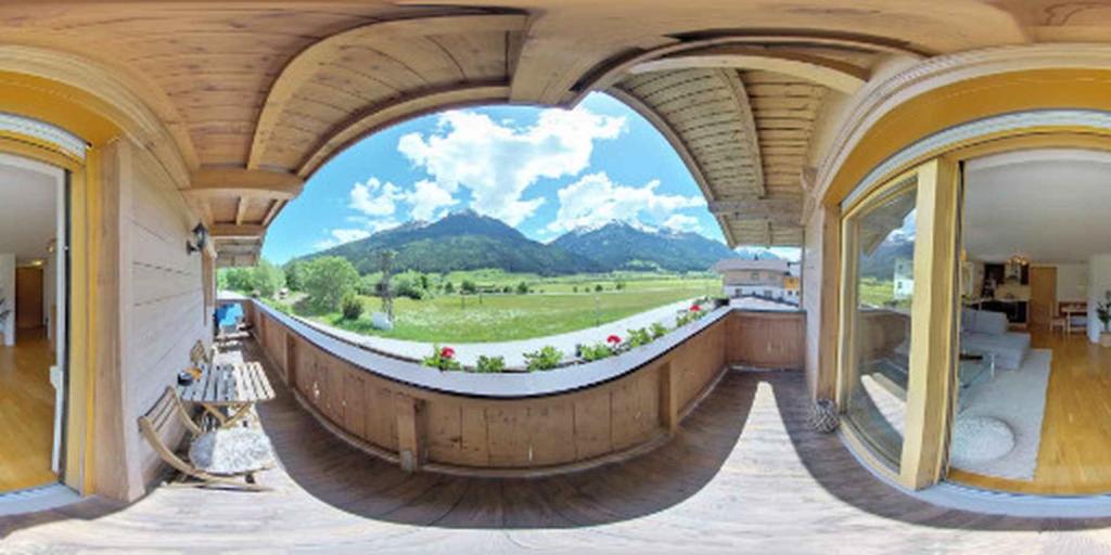 a room with a large window with a mountain view at Haus Weyerbach Apartments in Bramberg am Wildkogel