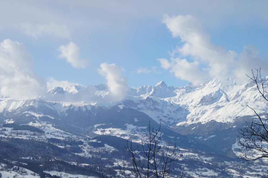 a view of a mountain range with snow covered mountains at GLMB - Location Mont-Blanc in Saint-Gervais-les-Bains
