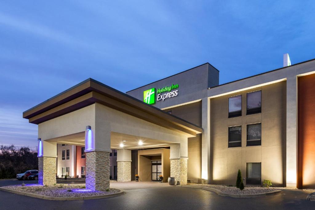 a hotel with a sign on the front of it at Holiday Inn Express - New Albany in New Albany