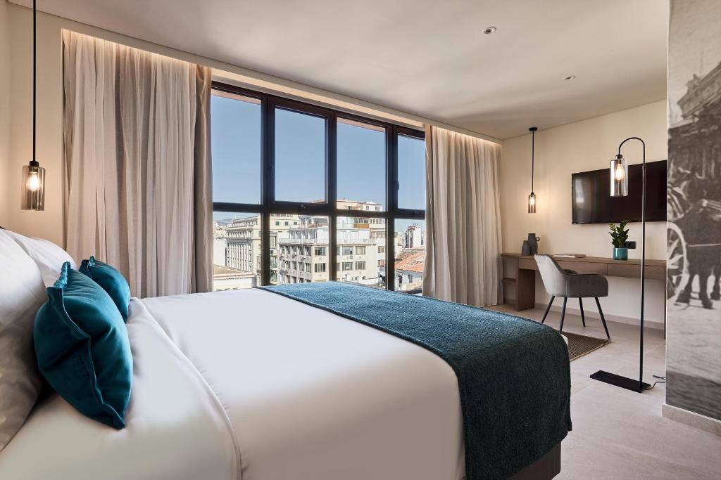 Postel nebo postele na pokoji v ubytování Athenarum Portus Life & Style Hotel