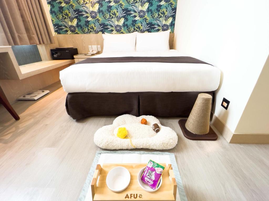 a hotel room with a bed and a tray of food at Formosan Naruwan Hotel in Taitung City
