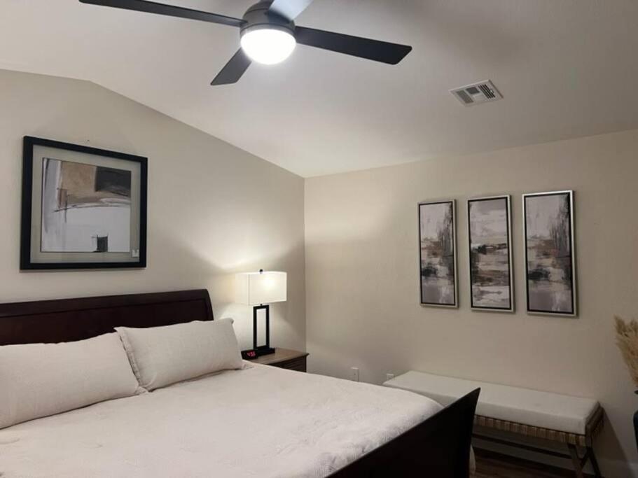 a bedroom with a bed with a ceiling fan at Mesquite Magic in Mesquite