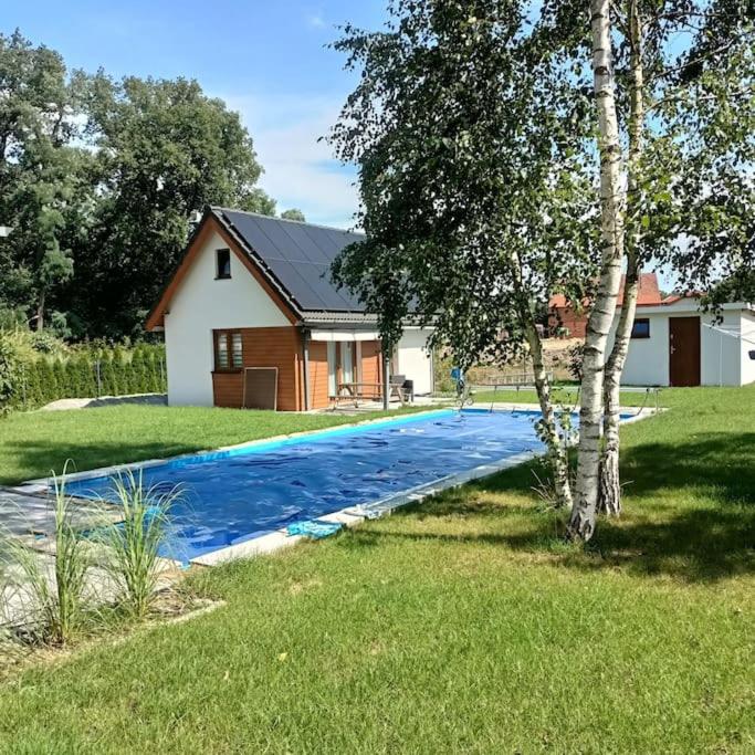 a house with a swimming pool in the yard at Cottage in Słup in Słup