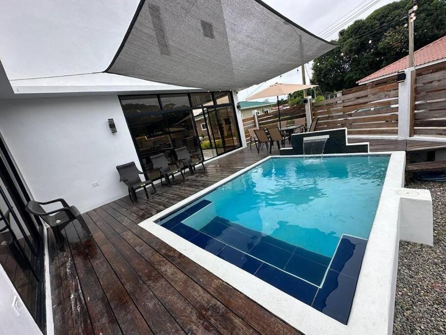 a large swimming pool sitting on a wooden deck at Villa Casa Blanca. in Puerto Cortés