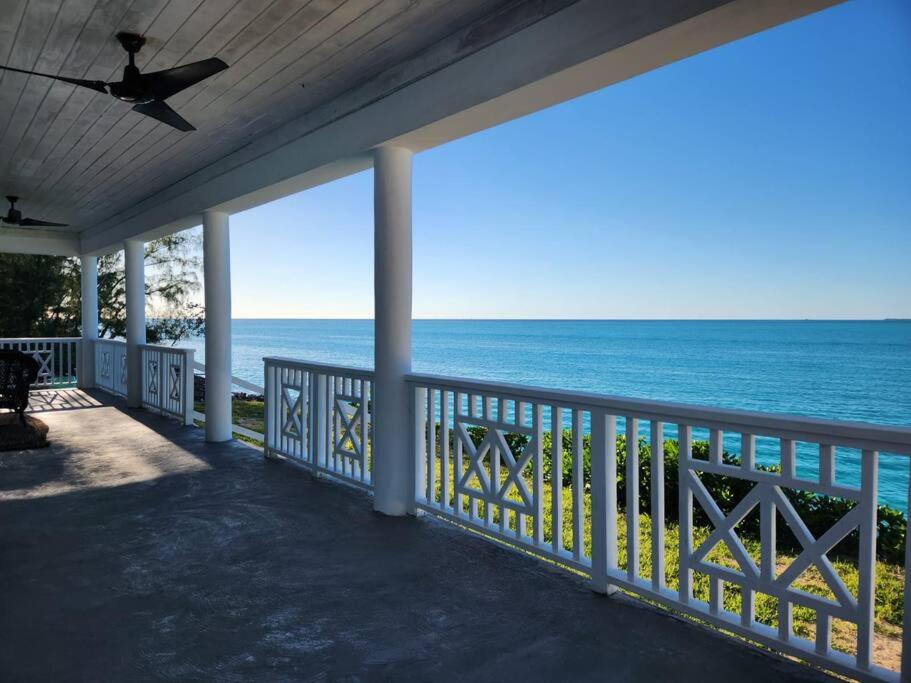 a porch with a view of the ocean at Turquoise Escapes in Black Point