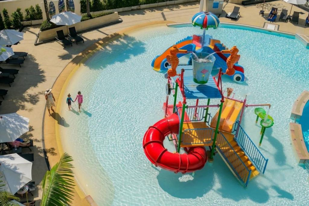 a large swimming pool with a water slide at Wyndham La Vita Rawai Phuket in Rawai Beach