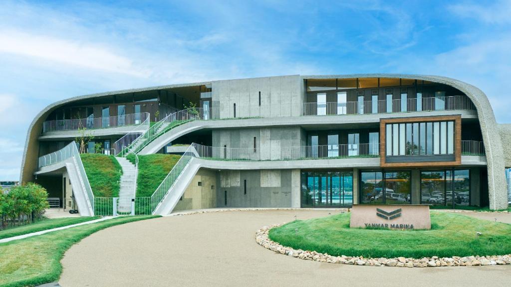 a large building with a staircase in front of it at YANMAR SUNSET MARINA CLUBHOUSE&HOTEL in Moriyama