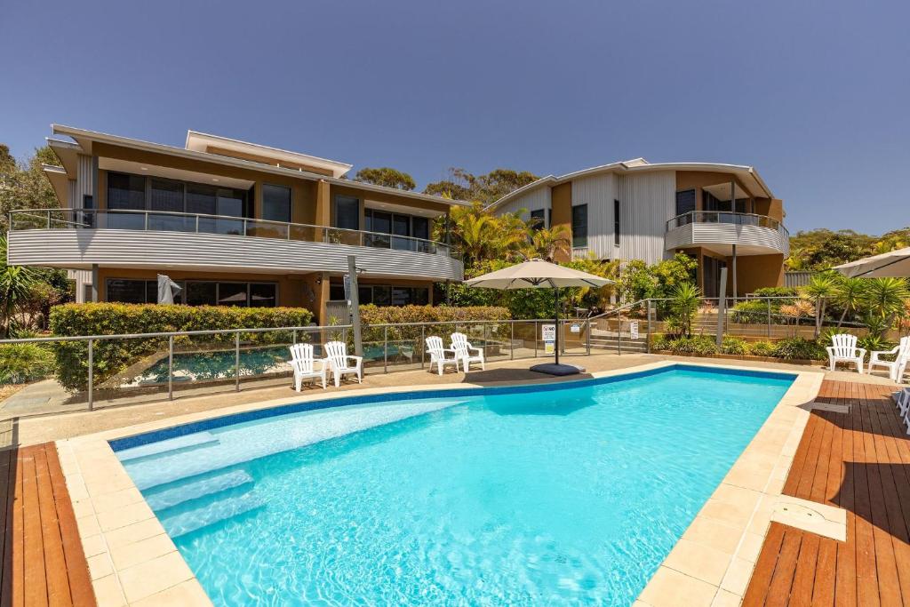 a swimming pool in front of a house at Boom 1 in Blueys Beach