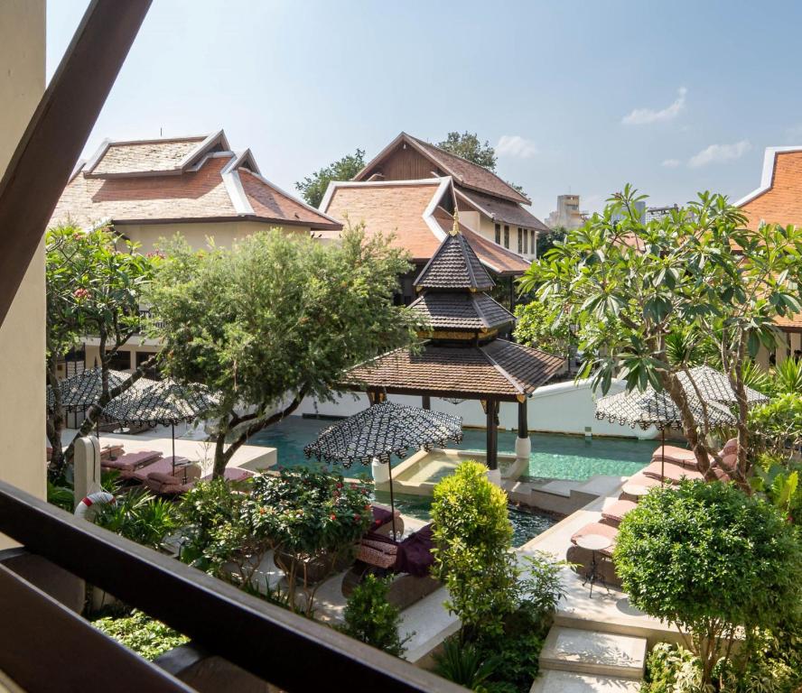 An elevated view over a landscaped resort courtyard and swimming pool.
