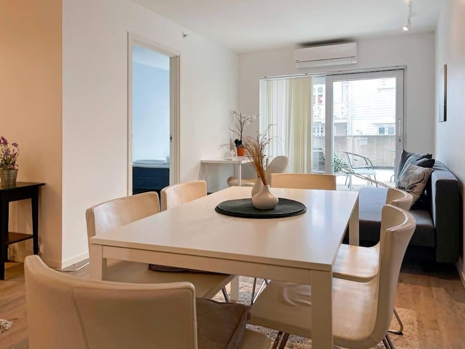 a living room with a dining room table and chairs at Unique Place by Stavanger BnB 19 (2BR, Terrace, Parking/Airport Shuttle) in Stavanger