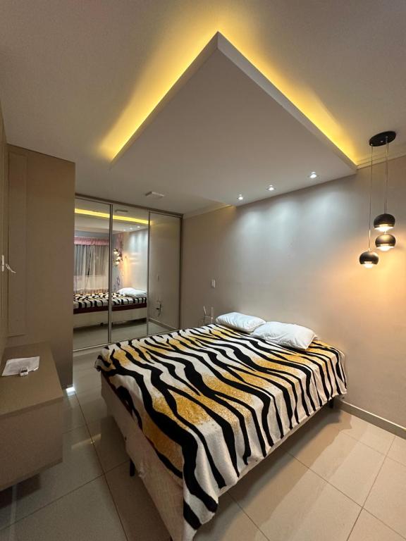 a bedroom with a zebra print bed in a room at Flat Cézar's Park in Caldas Novas