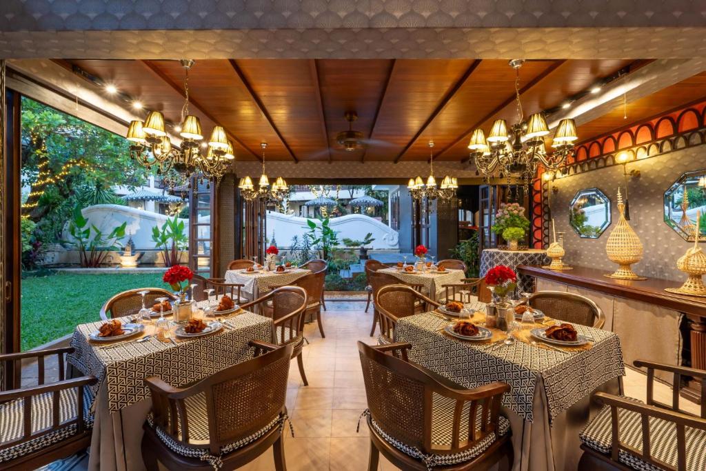 A chandelier-lit dining room opens onto a small green courtyard.