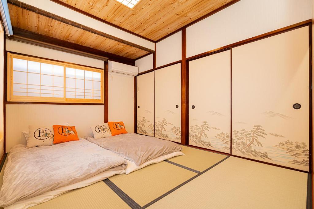 a room with a bed in the middle of it at 一戸建民泊 Tokyo St-ar House 東京星宿 in Tokyo