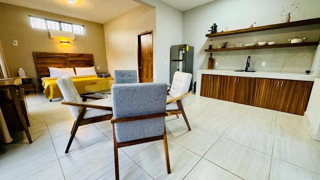 a living room with a table and chairs and a bedroom at Estudio a 5 minutos de Sayulita -Parota 1 in San Ignacio