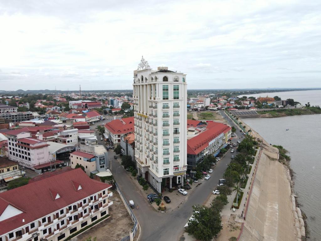 an aerial view of a city with a tall white building at Lbn Asian Hotel in Kampong Cham