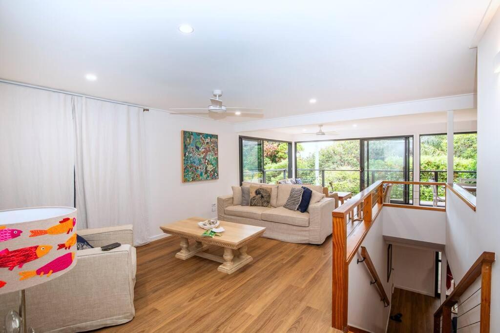 a living room with a couch and a table at Island Hideaway + 1 min to Cylinder Beach + Sleeps 10 in Point Lookout