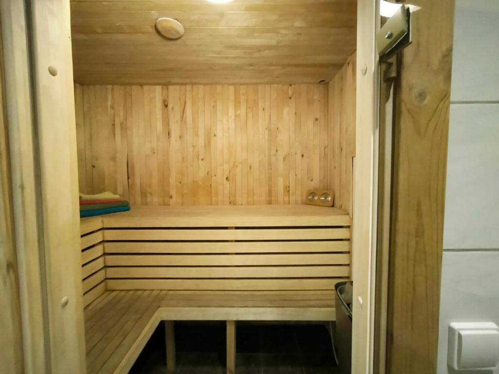 a wooden sauna with a bench in a room at PRIVATE SAUNA & 4 bedrooms Old Town Rooftop Apartment in Vilnius