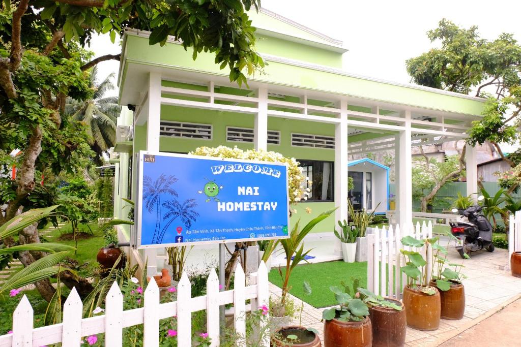a house with a sign in front of it at NAI Homestay in Ben Tre