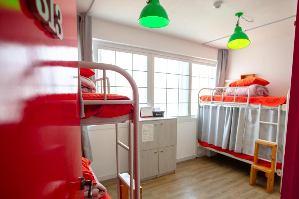 Postel nebo postele na pokoji v ubytování SUM Guesthouse Jeju Airport