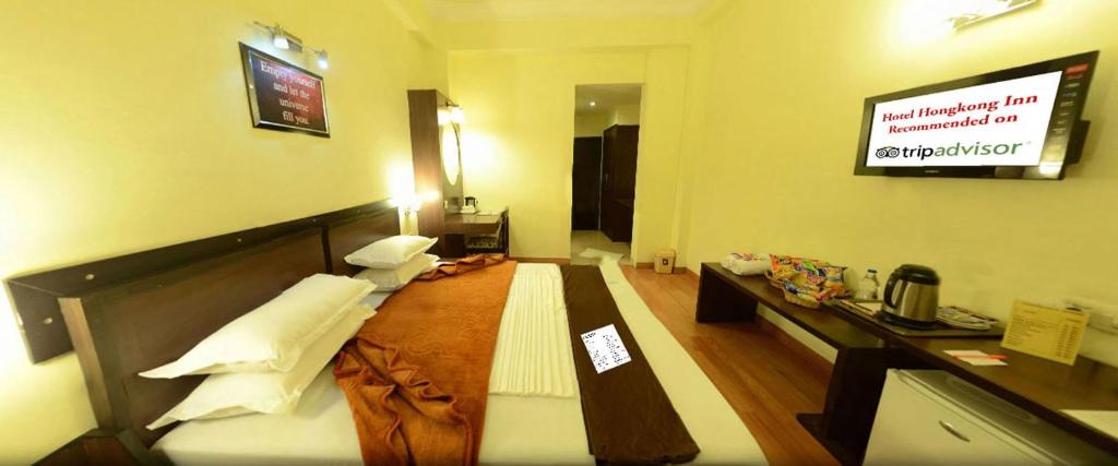 Postel nebo postele na pokoji v ubytování Hotel Hong Kong Inn