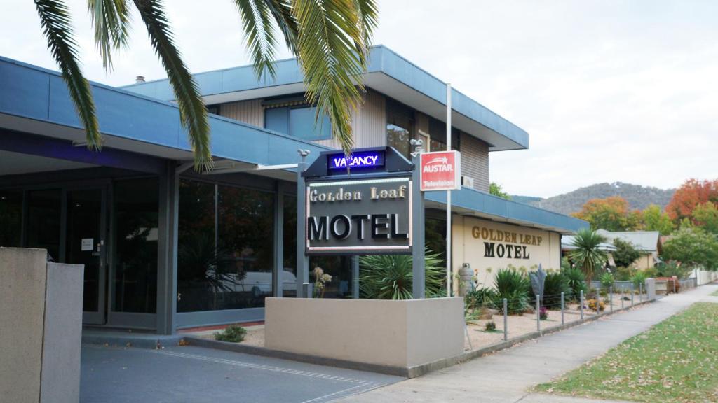 a building with a motel sign in front of it at Golden Leaf Motel in Myrtleford