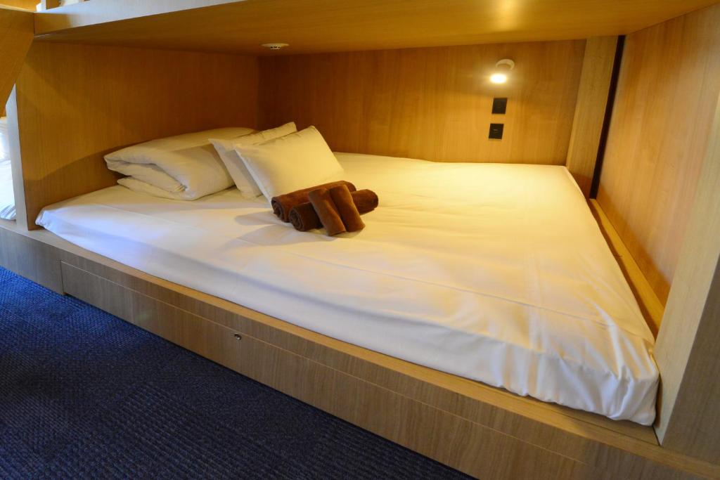 a teddy bear sitting on a bed in a room at THE BONDS HOTEL TOKYO in Tokyo