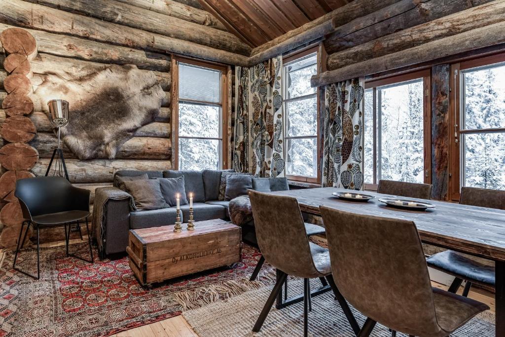 a living room with a couch and a table at Ruka Villa Pipo slopes, skiing, lake in Ruka