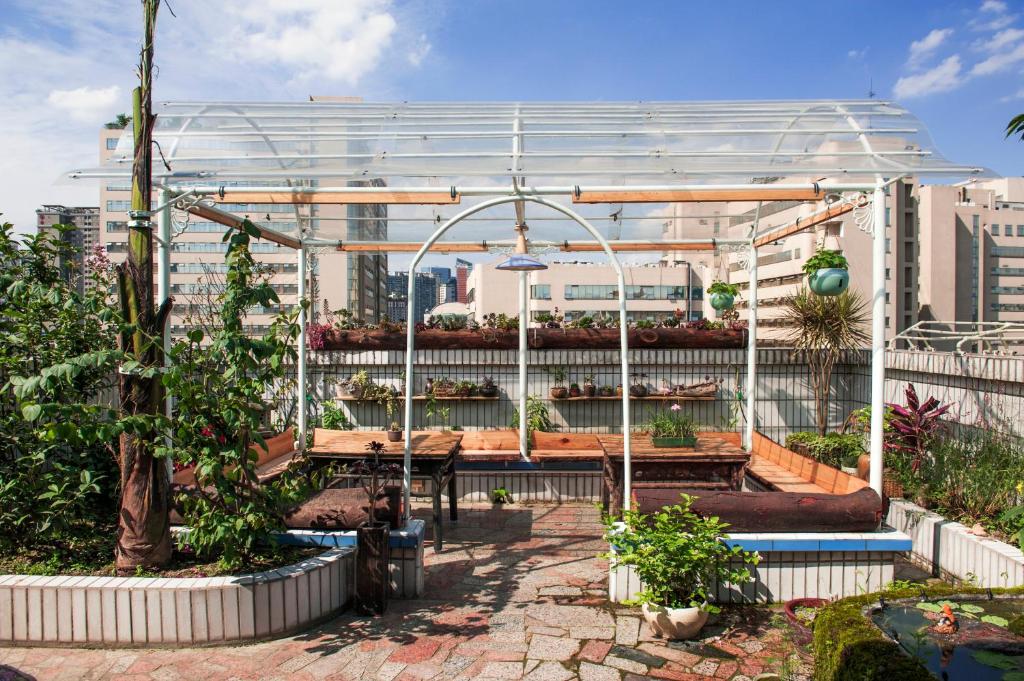 a greenhouse in a garden with plants in it at Arthur's Roof-Top in Chengdu