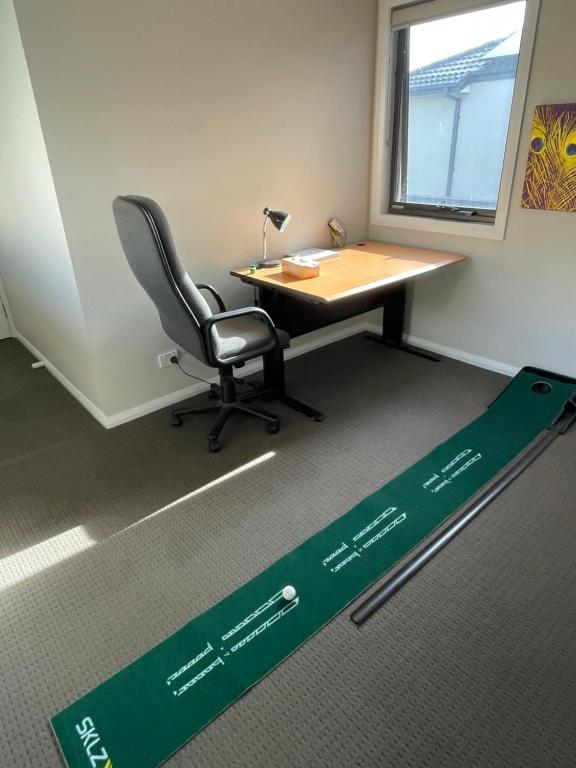 an office with a desk and a chair and a sign at Cosy Room with lock and work area in Truganina