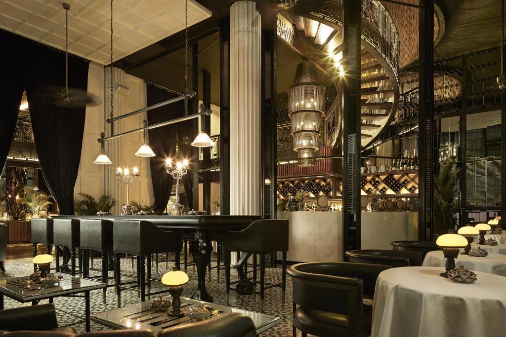 a restaurant with tables and chairs and a bar at Double - Six, Luxury Hotel - Seminyak in Seminyak