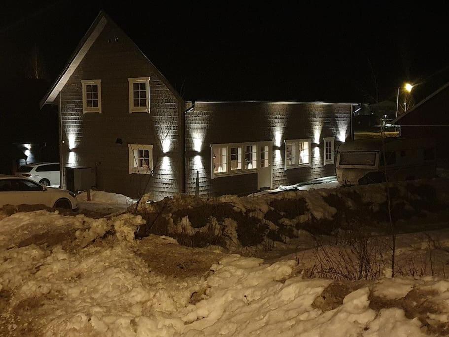a house at night with snow in front of it at Stuga i Branäs Byn in Sysslebäck