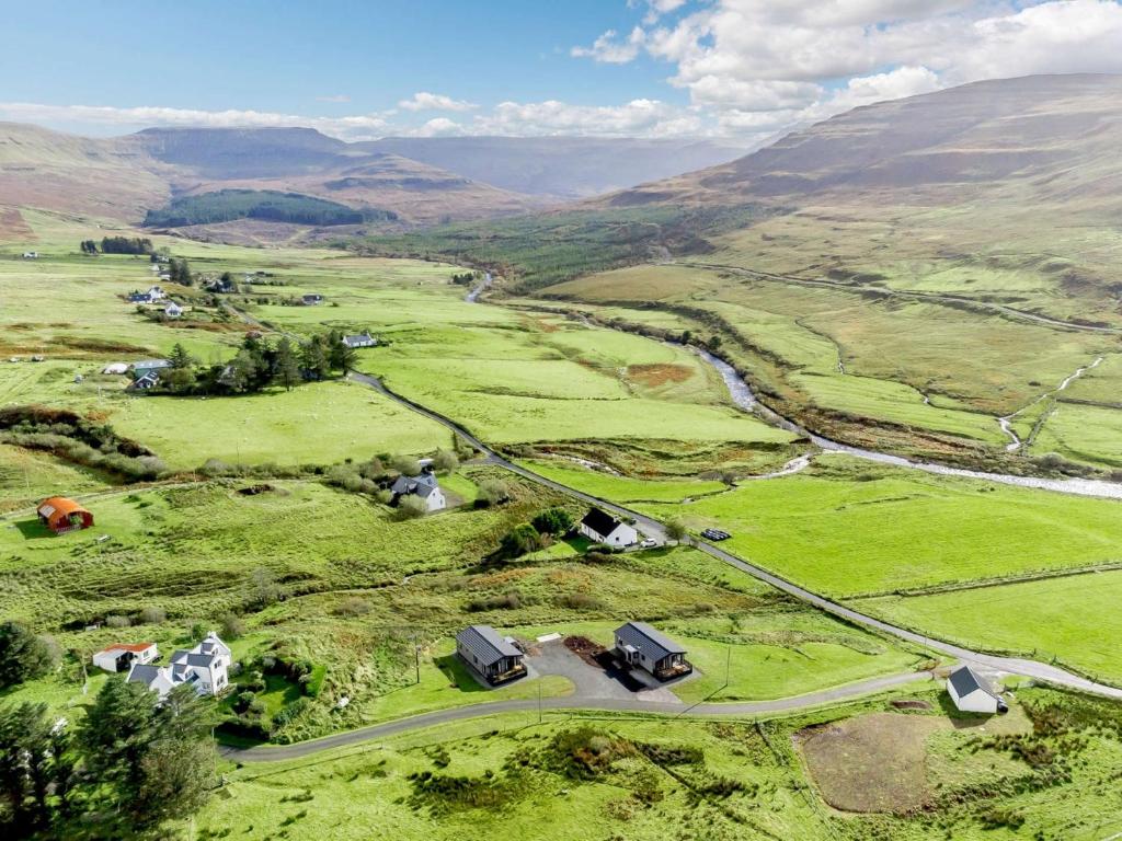 an aerial view of a farm in the hills at 2 Bed in Portree 87578 in Portree