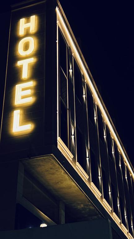 a lit up sign on the side of a building at Qimam Park Hotel Al-baha 7 in Al Baha