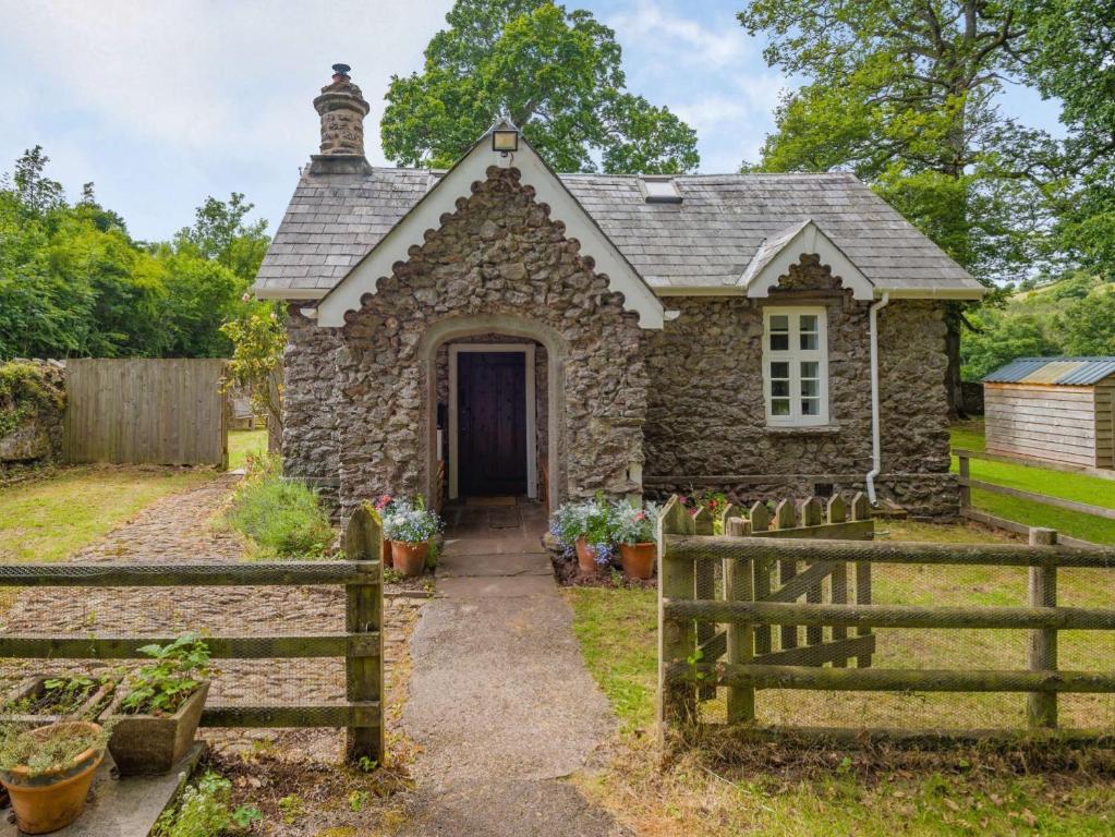 a stone house with a fence in front of it at 1 Bed in Brecon 88748 in Aber-Brân