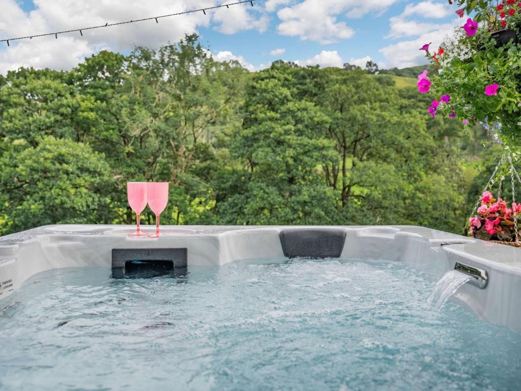 a hot tub in the backyard with a pink chair in it at 1 Bed in Patterdale 89510 in Deepdale