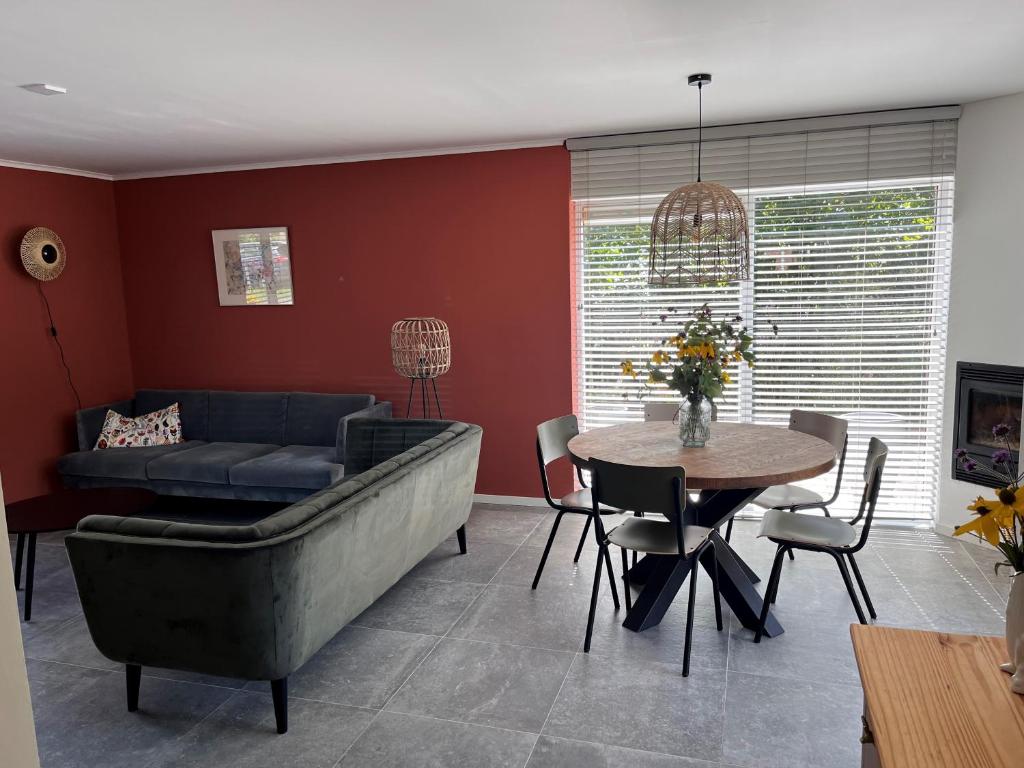 un soggiorno con divano e tavolo di Cosy Vacation home with large fenced garden a Bruinisse