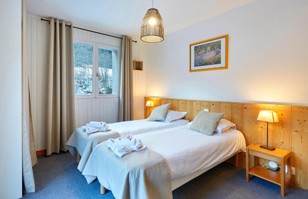 Postel nebo postele na pokoji v ubytování Hôtel Eliova l'Eau Vive