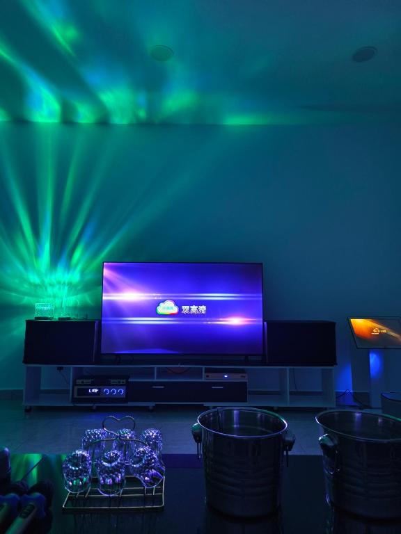 a living room with a flat screen tv on a entertainment center at PandaHomestay28 in Skudai
