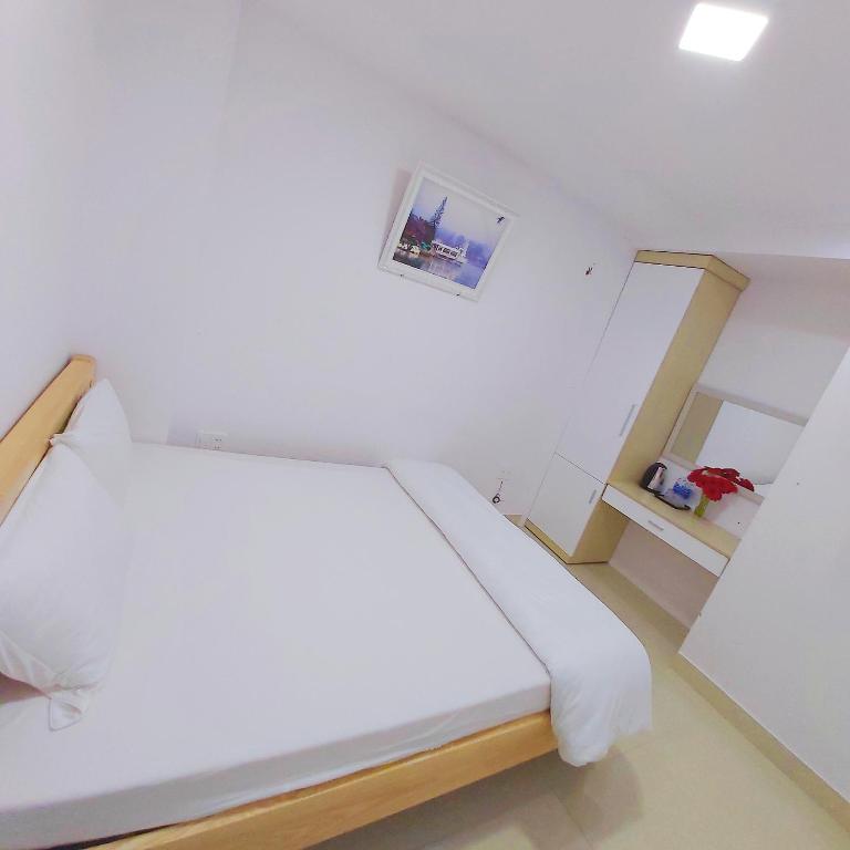 Postel nebo postele na pokoji v ubytování Daisy Dalat House