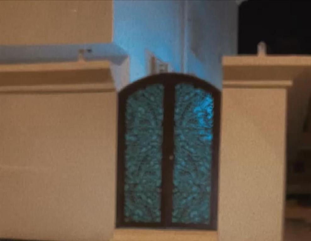 a window in a room with a blue wall at شقق السلام المخدومة in Al Madinah