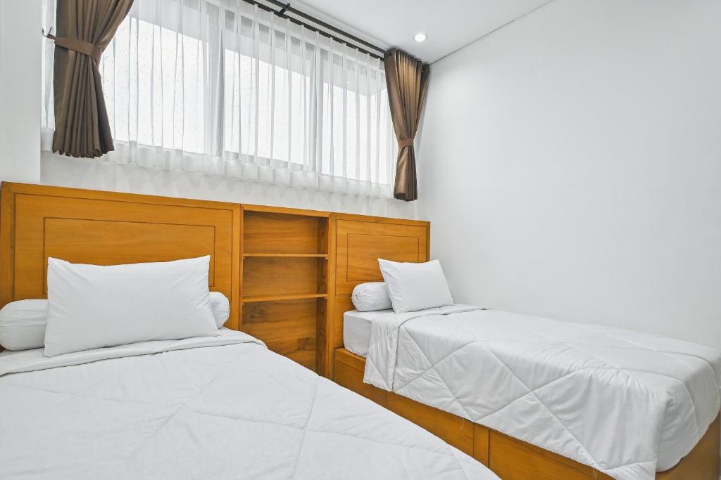 Postel nebo postele na pokoji v ubytování Bangreng Inn Hotel