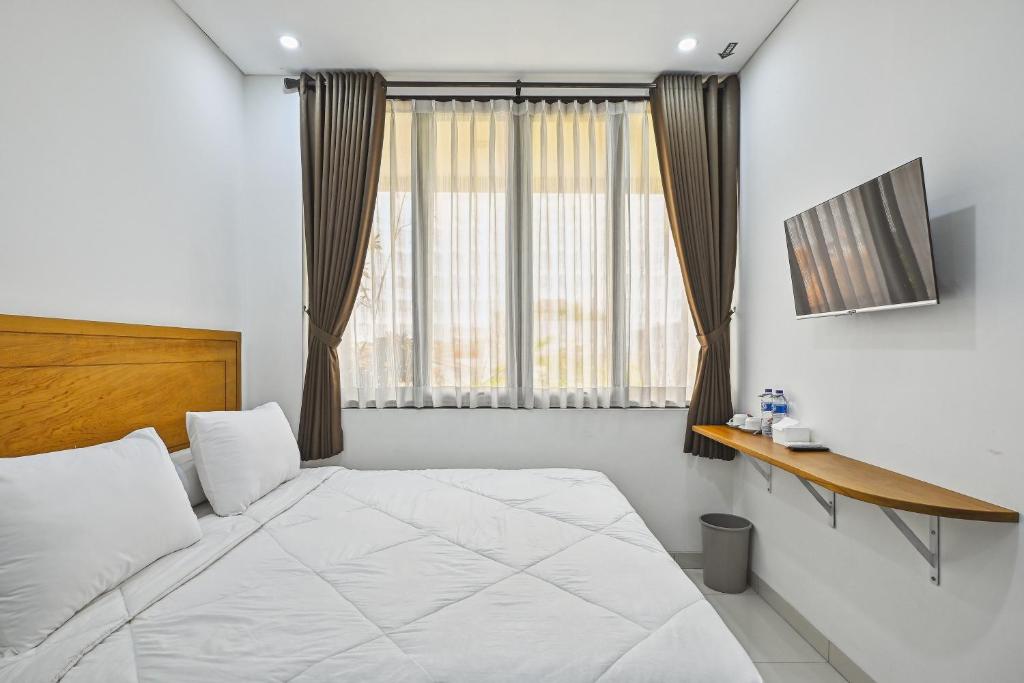 Postel nebo postele na pokoji v ubytování Bangreng Inn Hotel