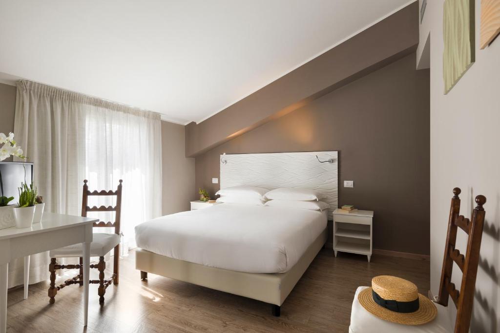 Postel nebo postele na pokoji v ubytování Albergo La Pace