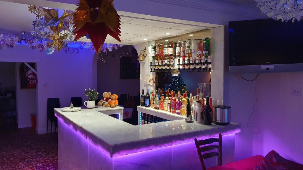 a bar in a room with purple lighting at Savona Hotel in Skegness