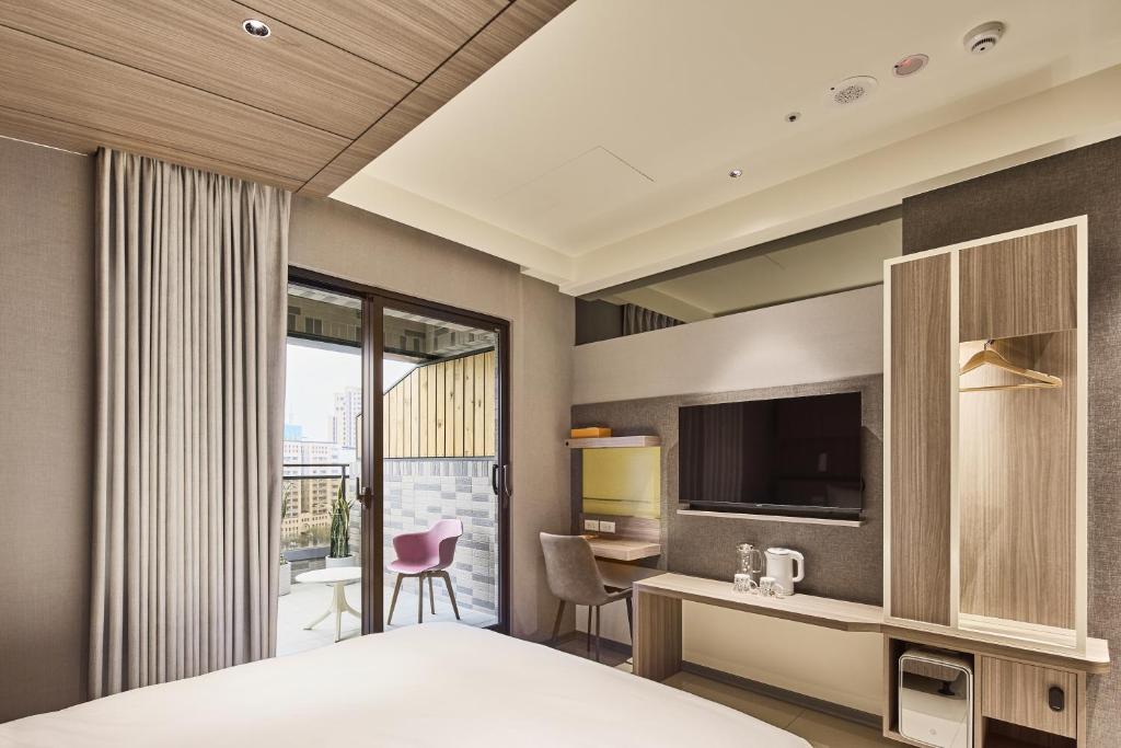 Postel nebo postele na pokoji v ubytování Orange Hotel -Hanzhong, Taipei