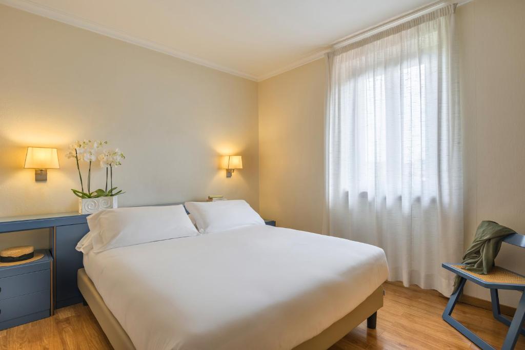 Postel nebo postele na pokoji v ubytování Albergo La Pace