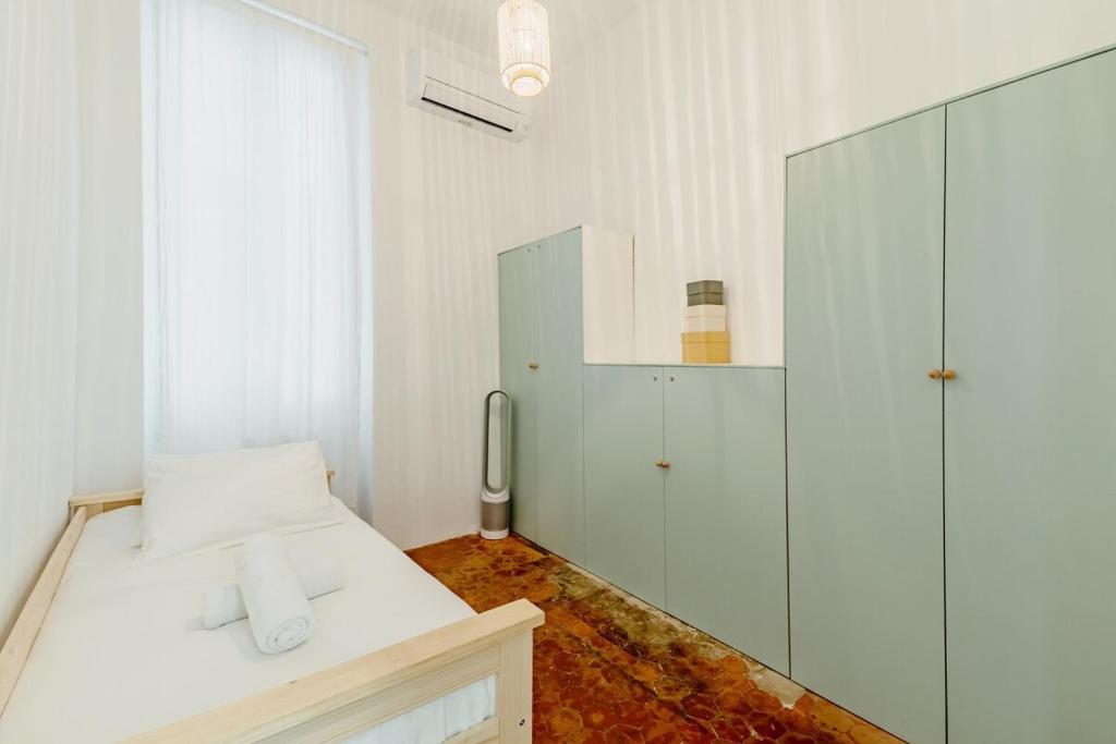 a white room with a bed and a glass shower at |Aaa|- Pure &amp; Natural Massilia City Center in Marseille