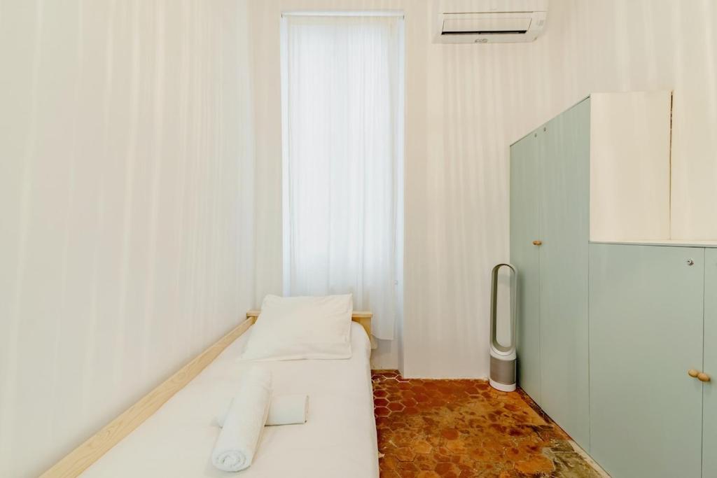 a white room with a bed and a window at |Aaa|- Pure &amp; Natural Massilia City Center in Marseille