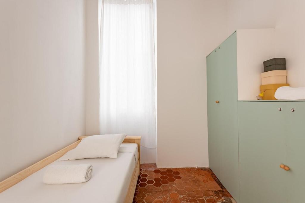 a small bedroom with a bed and a mirror at |Aaa|- Pure &amp; Natural Massilia City Center in Marseille